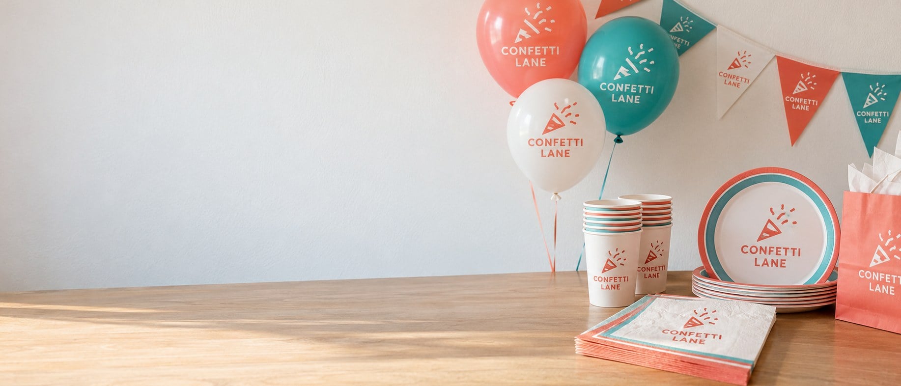 Custom printed party napkins, cups and balloons on a party table